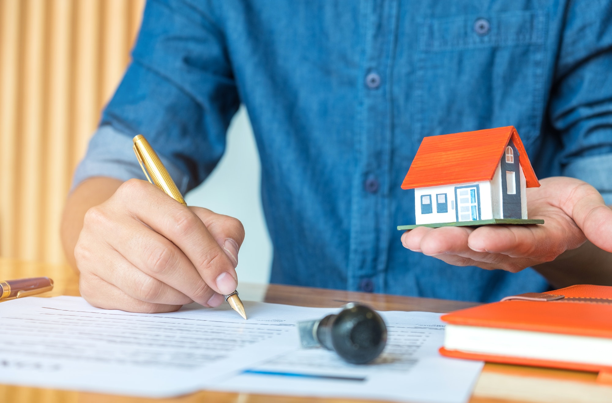 Architects are writing home plan with house model.